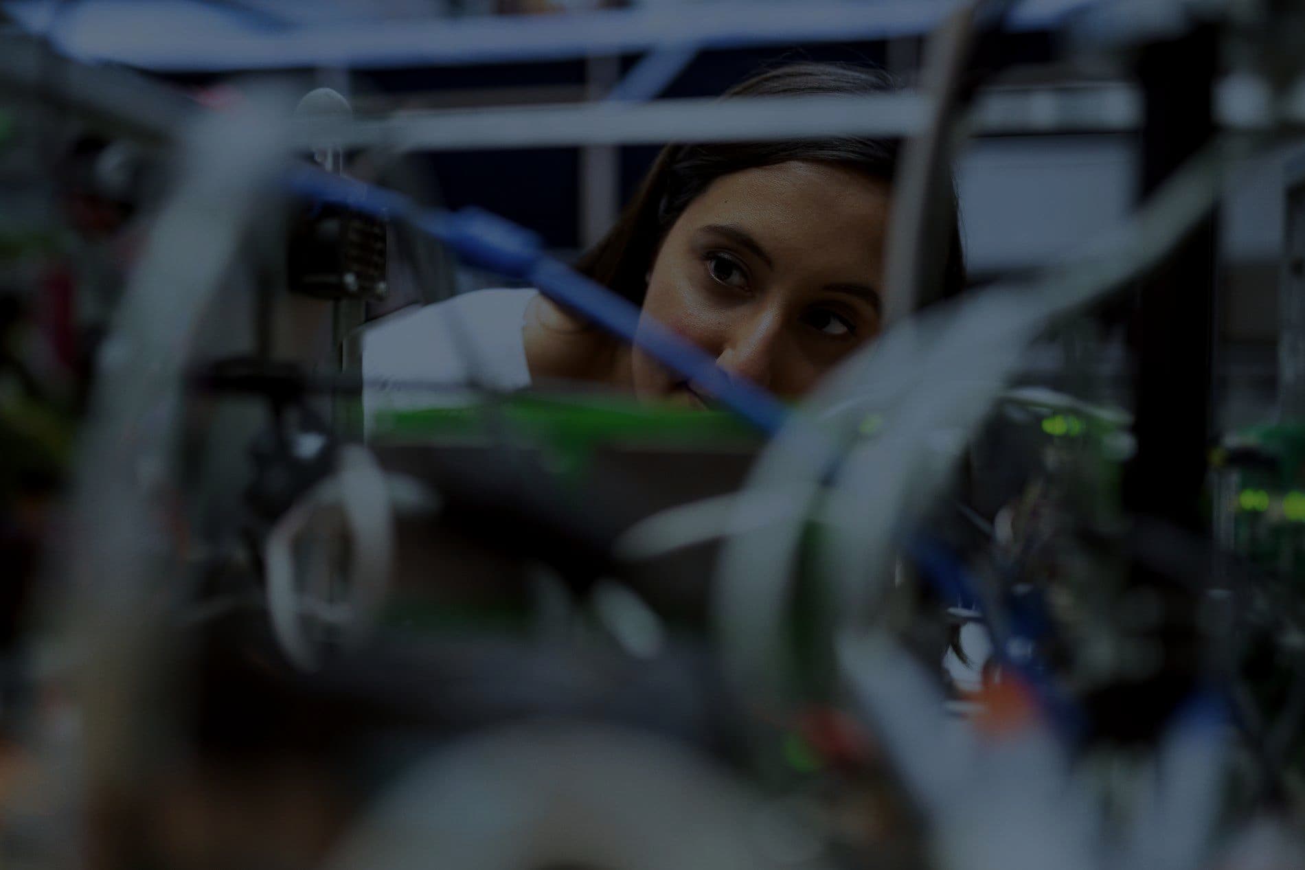 An engineer working through wiring on a hardware assembly