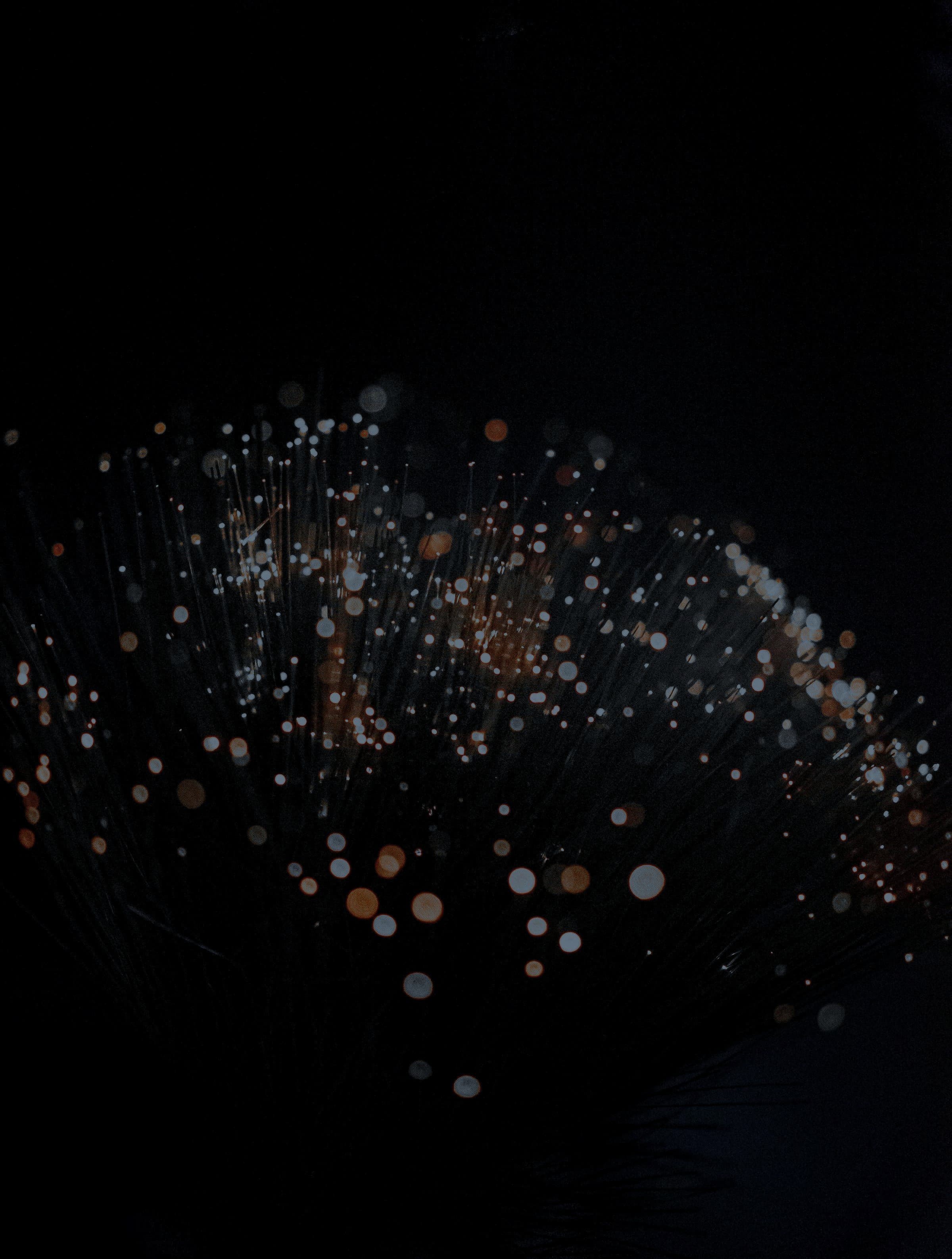 Glowing tips of fibre-optic strands in the dark