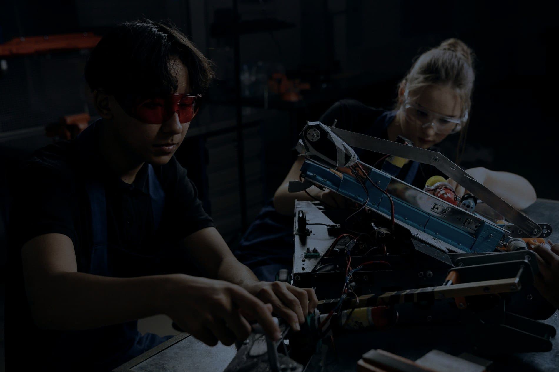 Engineers working together on a complex machine assembly
