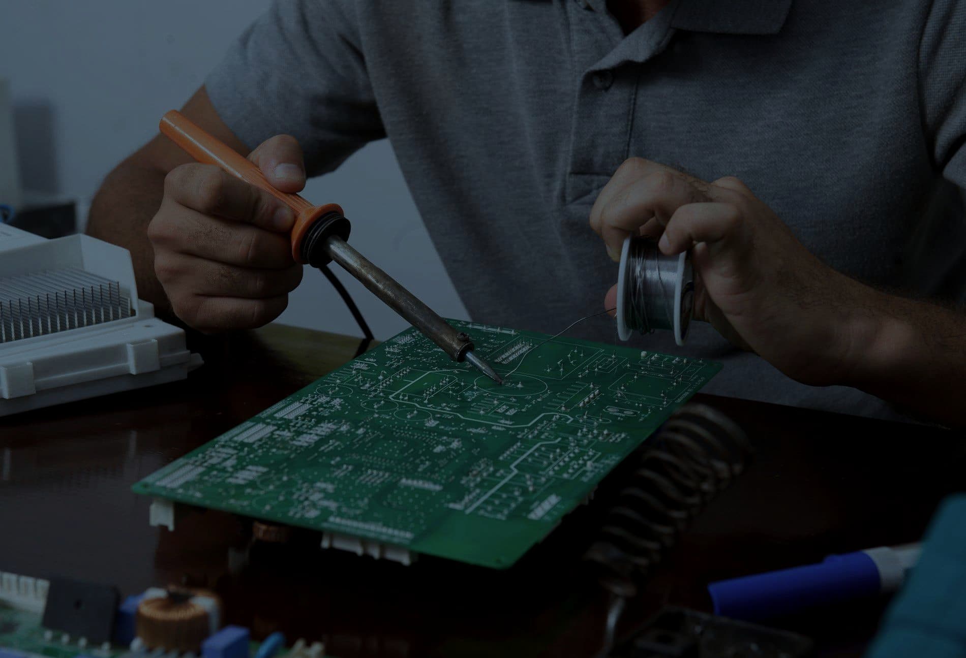 An engineer soldering components onto a circuit board