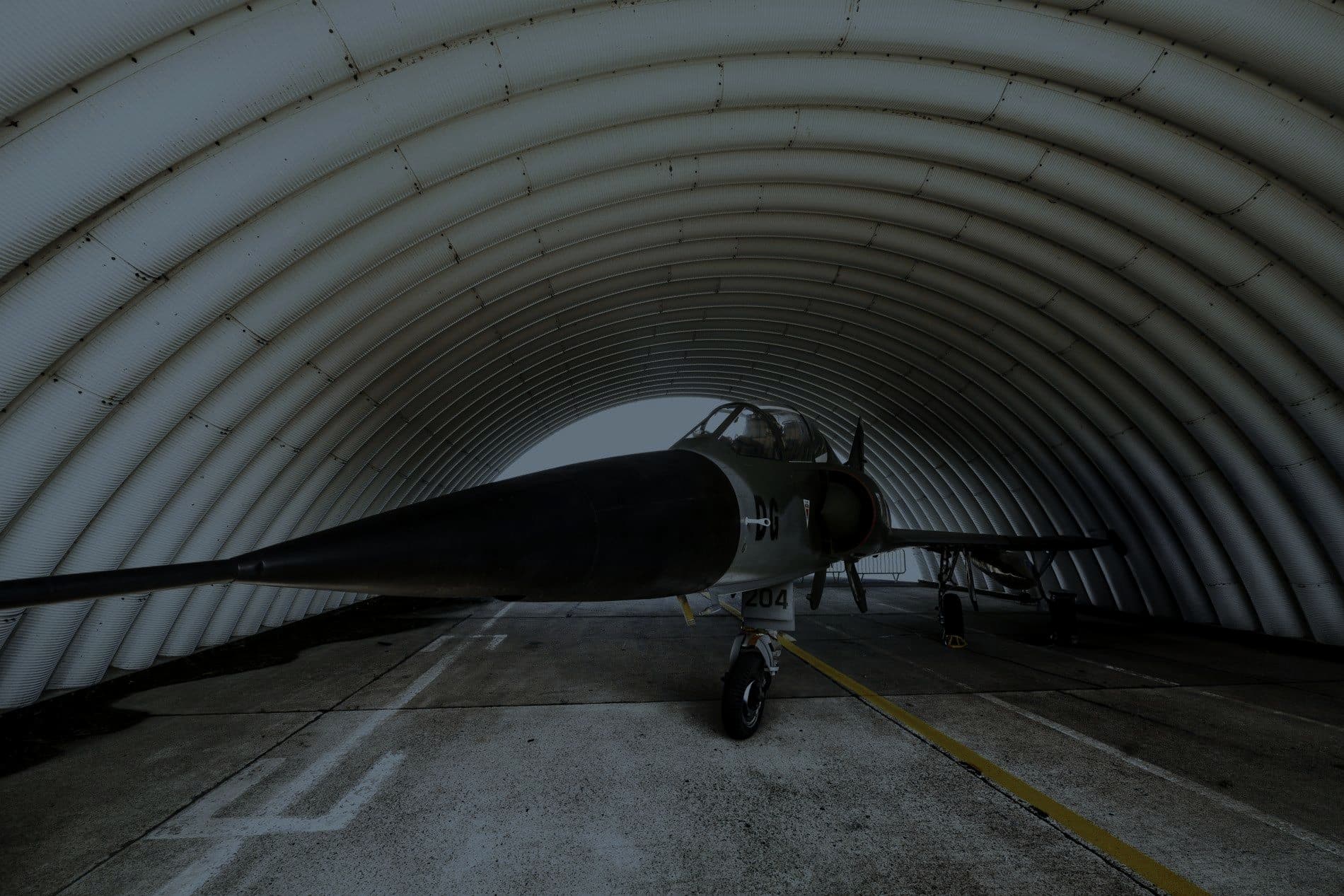 A military jet parked inside a hardened aircraft shelter