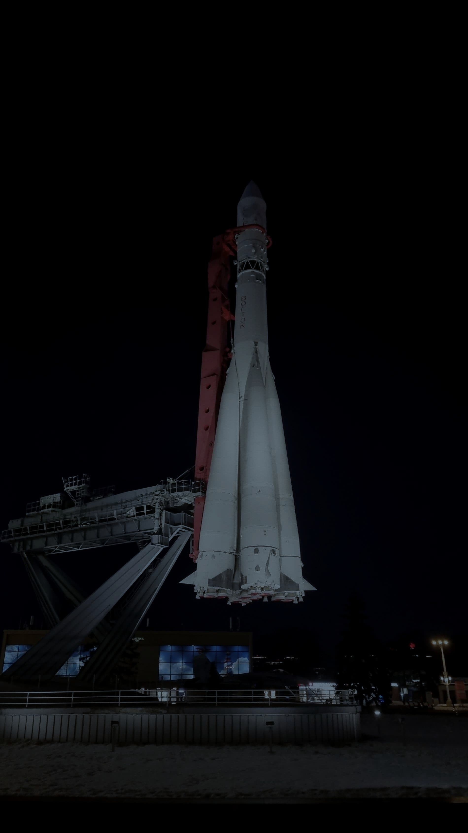 A rocket standing on its launch pad at night