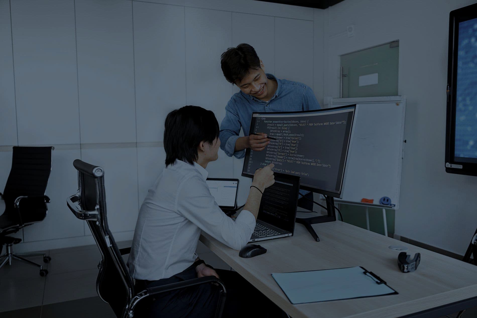 Engineers working together at computer workstations