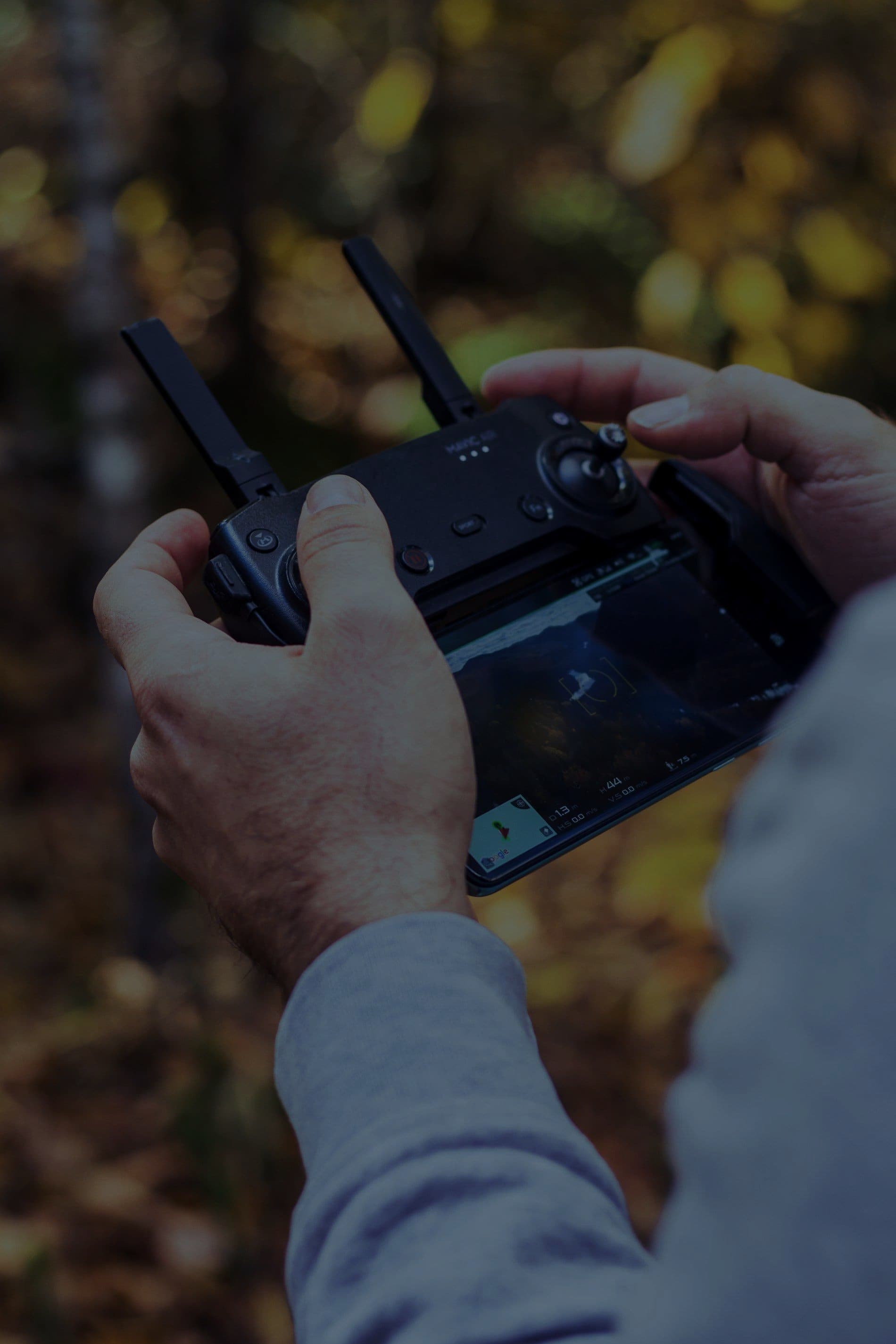 Hands holding a drone remote controller